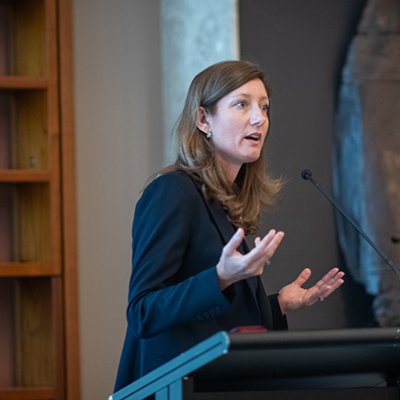 Professor Nicole Gillespie speaking at a podium